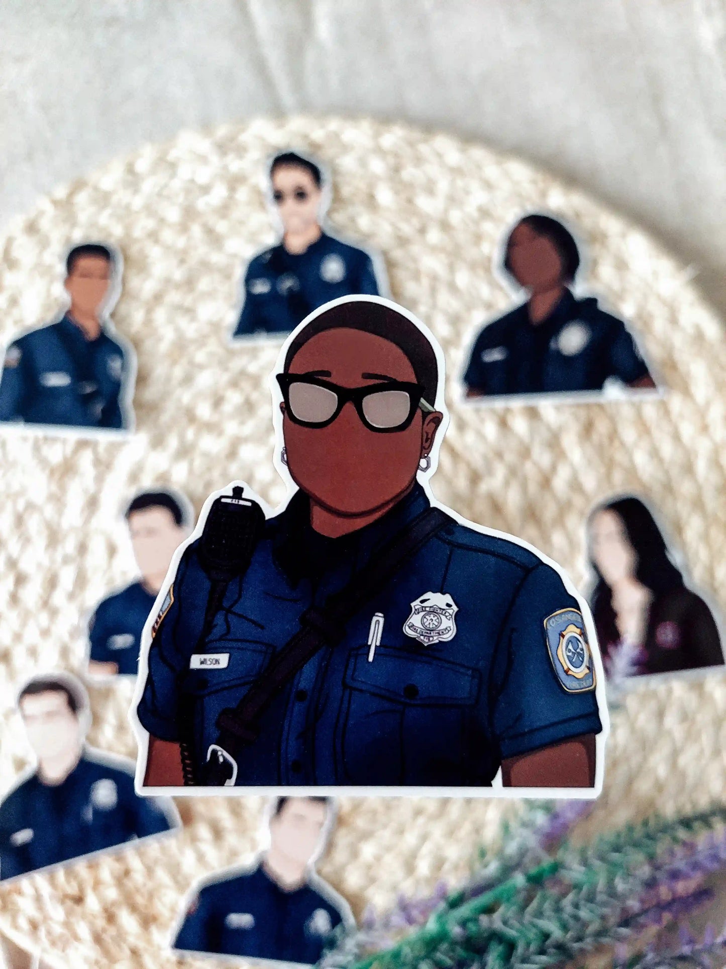 Close up photo of a vinyl sticker inspired by 9-1-1, featuring Hen Wilson.