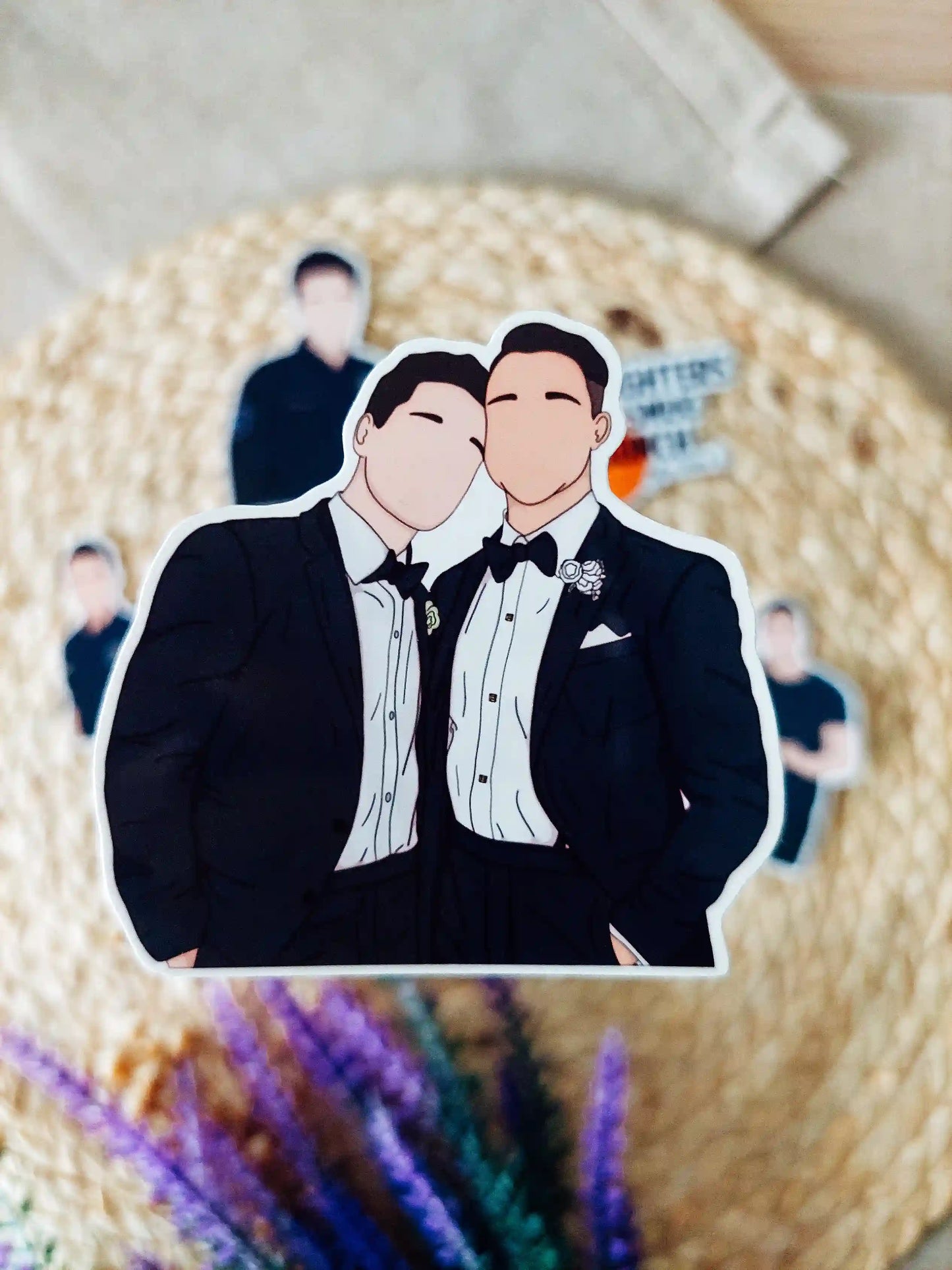 Close up photo of a vinyl sticker inspired by 9-1-1 Lone Star, featuring TK Strand and Carlos Reyes at their wedding.
