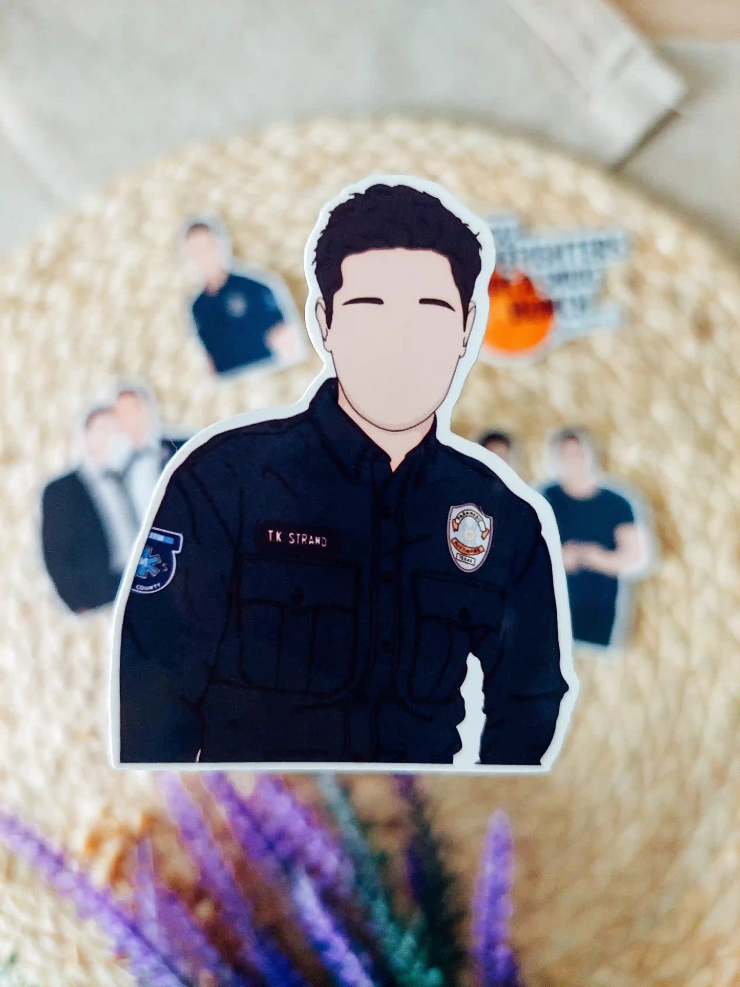 Close up photo of a vinyl sticker inspired by 9-1-1 Lone Star, featuring TK Strand.