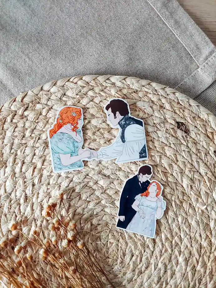 Close up photo of two vinyl stickers inspired by Bridgerton, featuring Penelope and Colin.