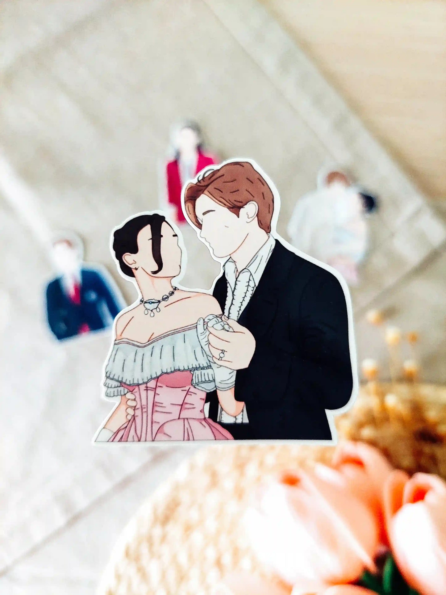 Close up photo of a vinyl sticker inspired by Maxton Hall, featuring Ruby Bell and James Beaufort.