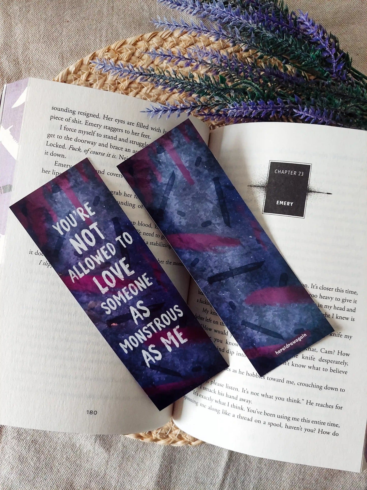 My Blade, Your Back inspired bookmarks displayed on an open book, featuring a purple and pink background with dagger illustrations and the quote "You're not allowed to love someone as monstrous as me".