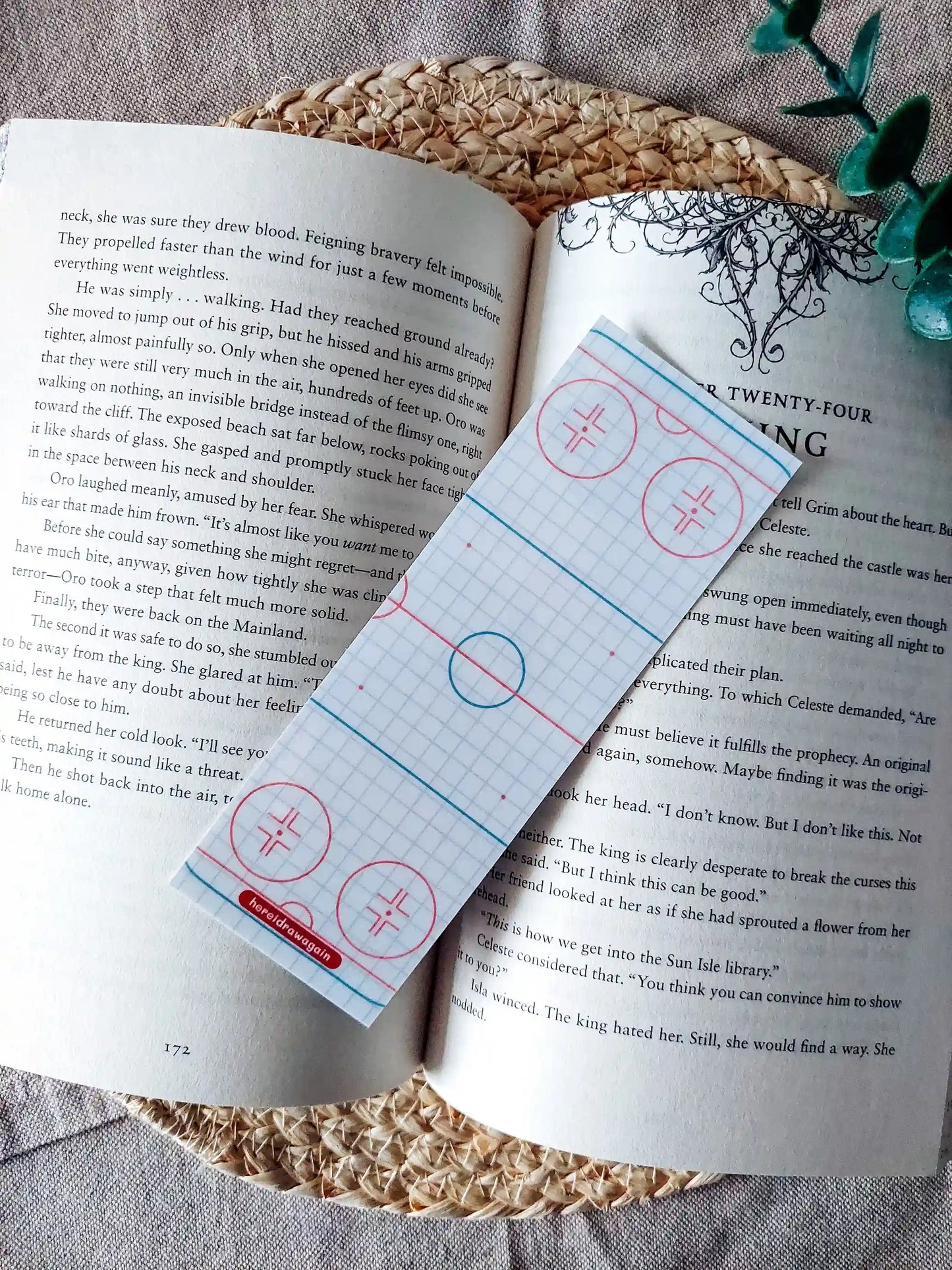 Off Campus inspired bookmark displayed on an open book, featuring hockey rink patterned background.