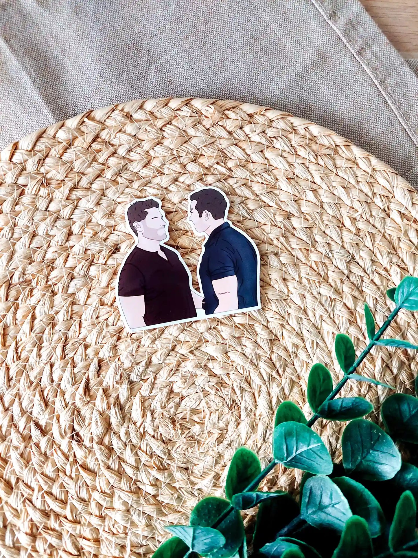 Close up photo of a vinyl sticker inspired by 9-1-1, featuring Buck and Tommy.