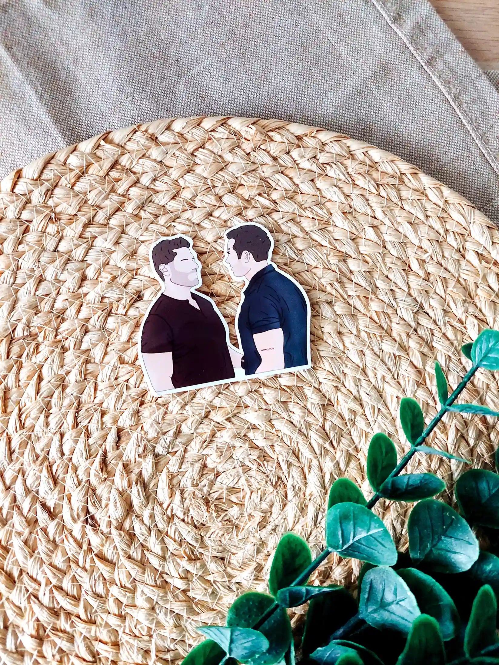 Close up photo of a vinyl sticker inspired by 9-1-1, featuring Buck and Tommy.