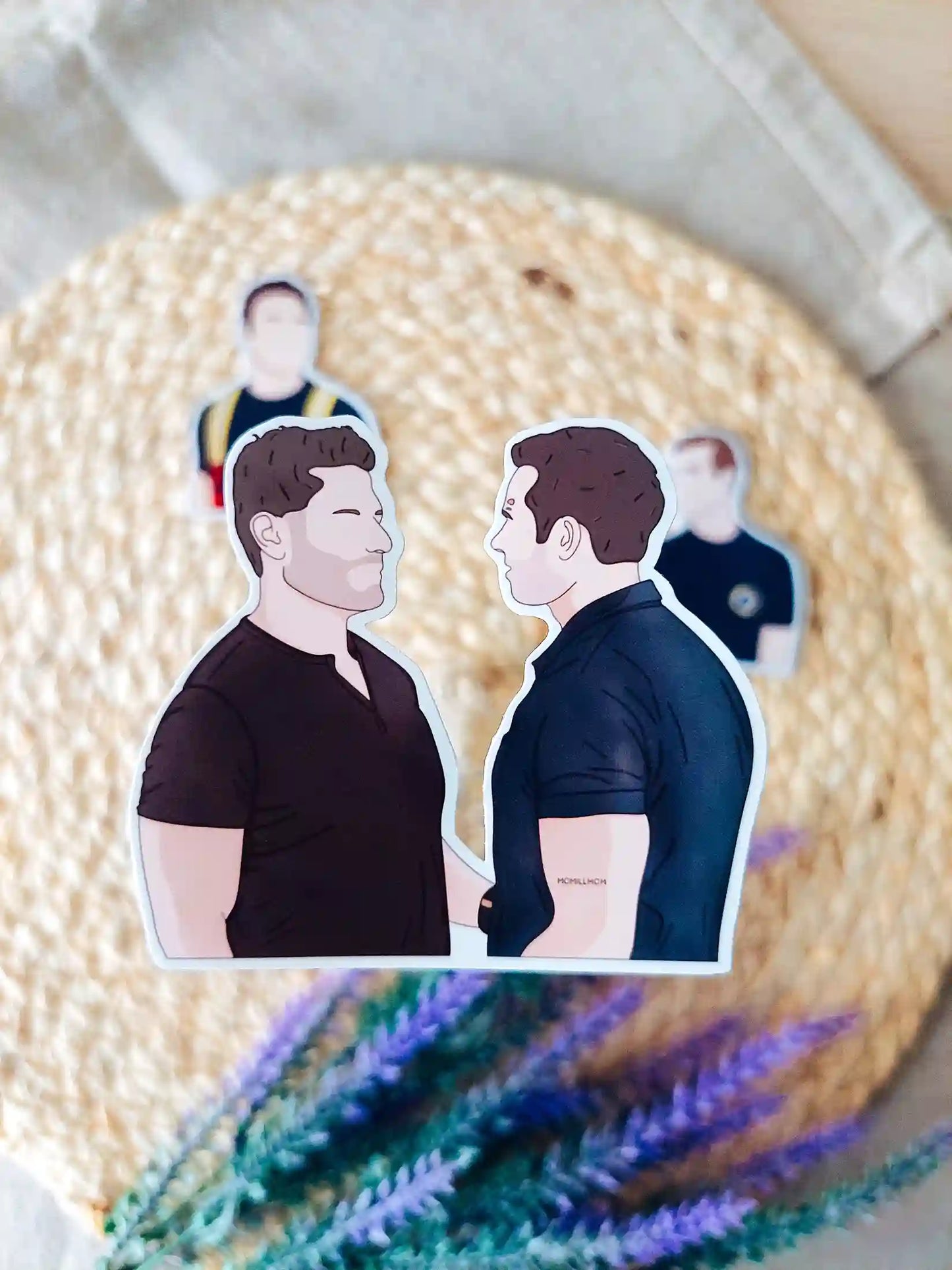 Close up photo of a vinyl sticker inspired by 9-1-1, featuring Buck and Tommy.