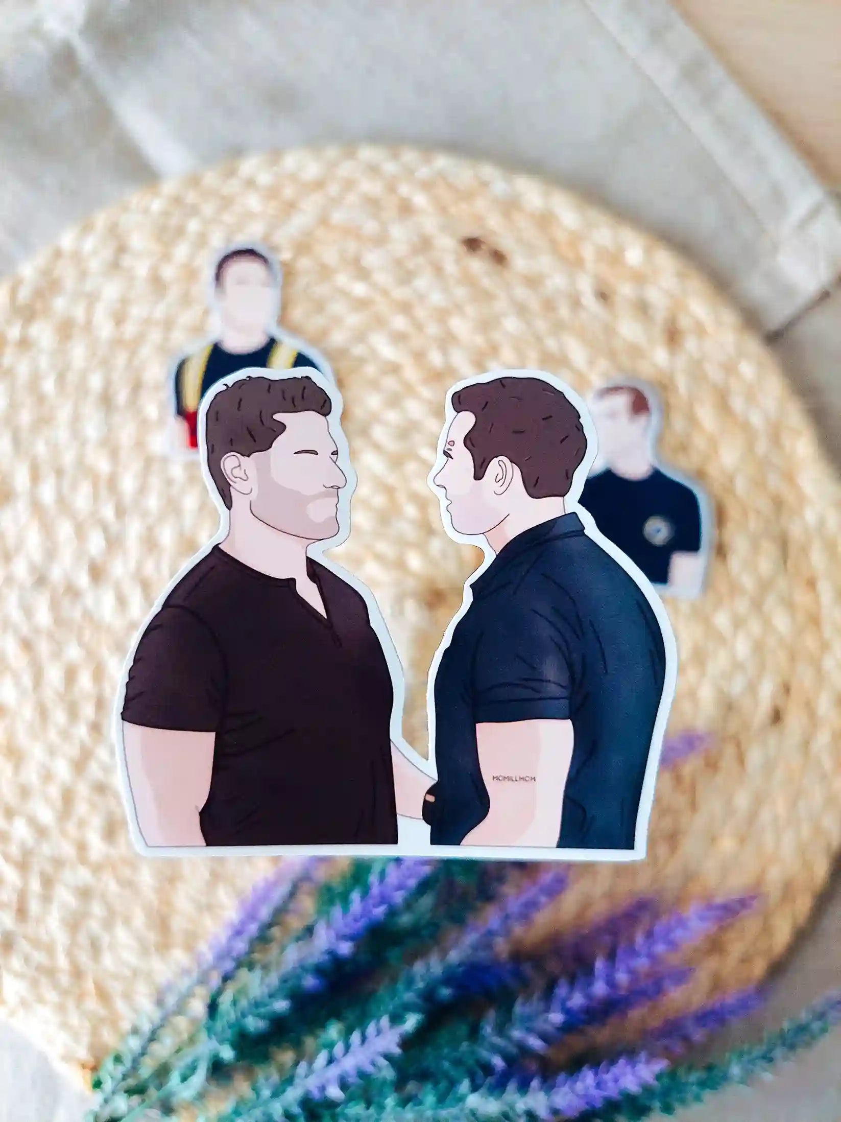 Close up photo of a vinyl sticker inspired by 9-1-1, featuring Buck and Tommy.