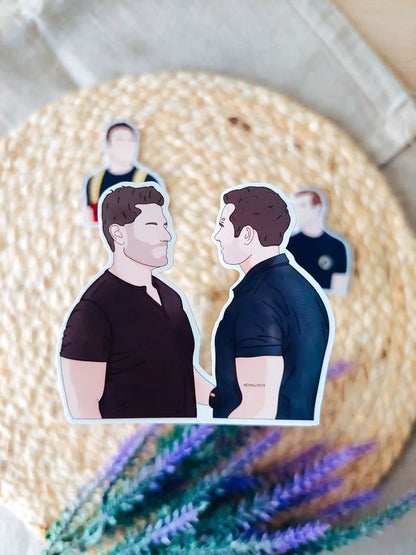 Close up photo of a vinyl sticker inspired by 9-1-1, featuring Buck and Tommy.