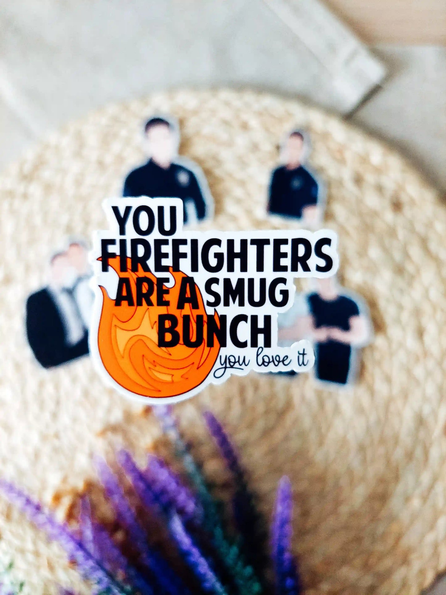 Close up photo of a vinyl sticker inspired by 9-1-1 Lone Star, featuring featuring the quote "You firefighters are a smug bunch, you love it".