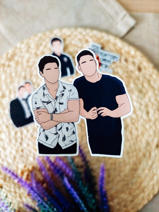 Close up photo of a vinyl sticker inspired by 9-1-1 Lone Star, featuring TK Strand and Carlos Reyes.