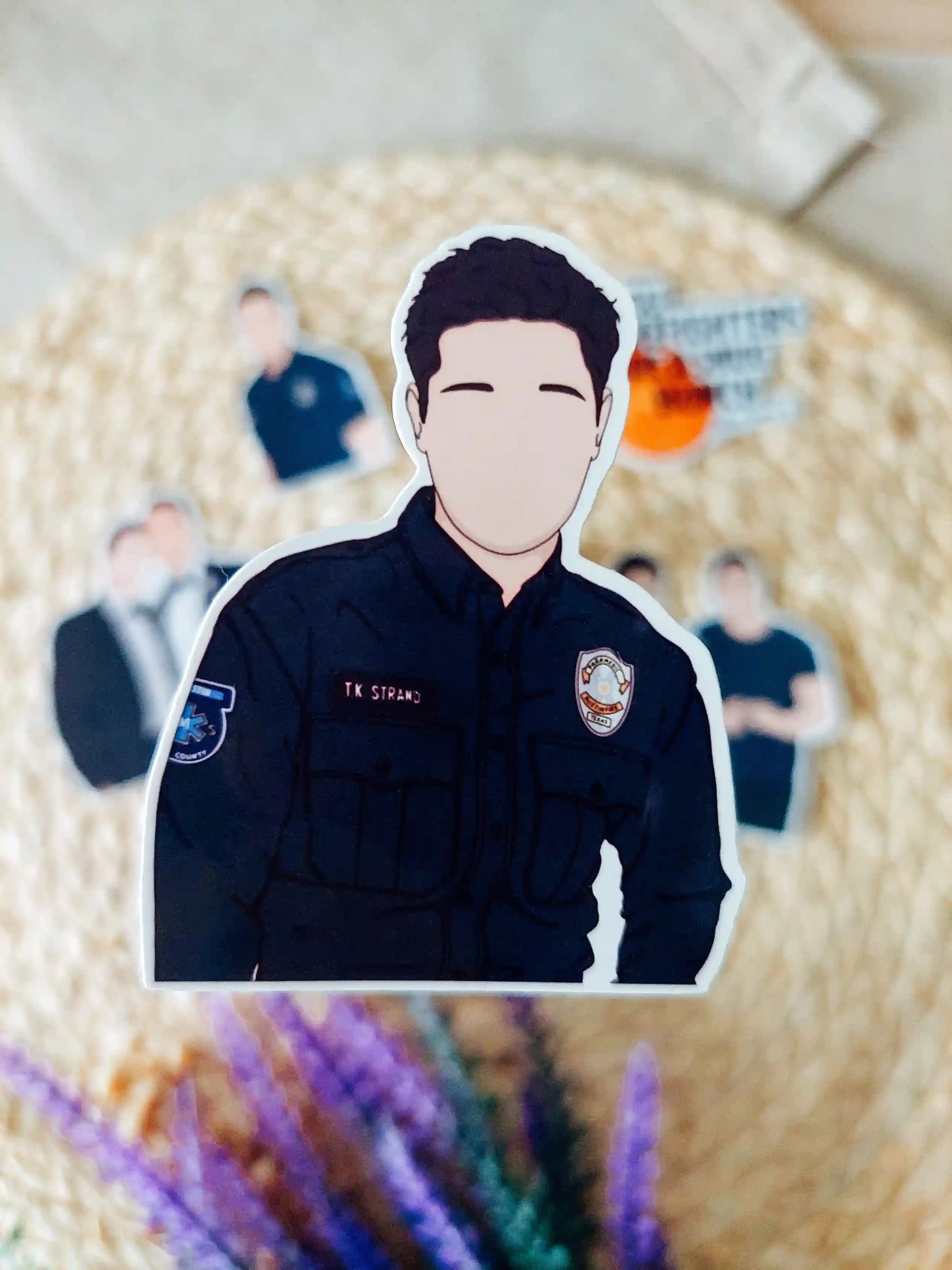 Close up photo of a vinyl sticker inspired by 9-1-1 Lone Star, featuring TK Strand.