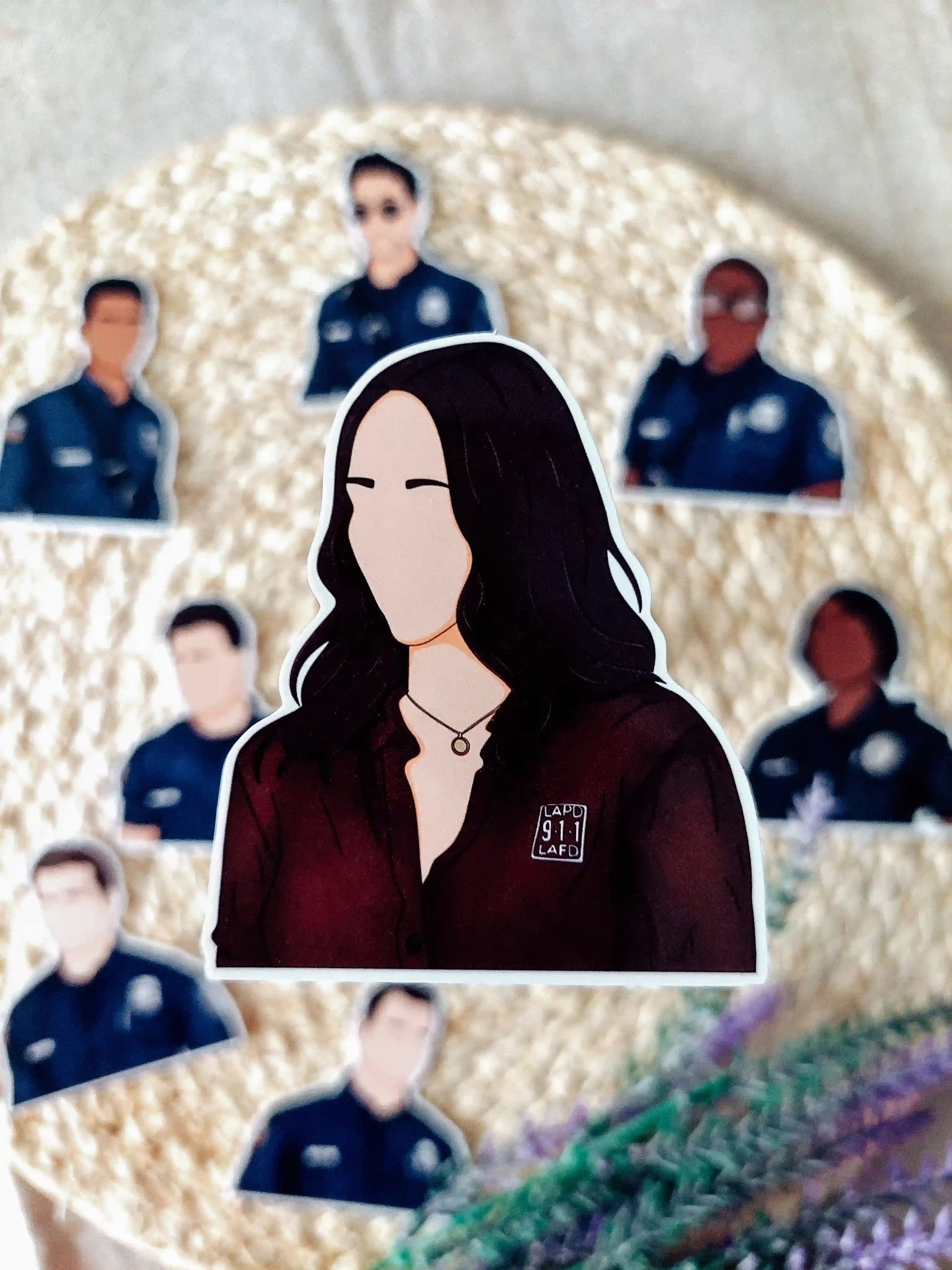 Close up photo of a vinyl sticker inspired by 9-1-1, featuring Maddie Buckley.