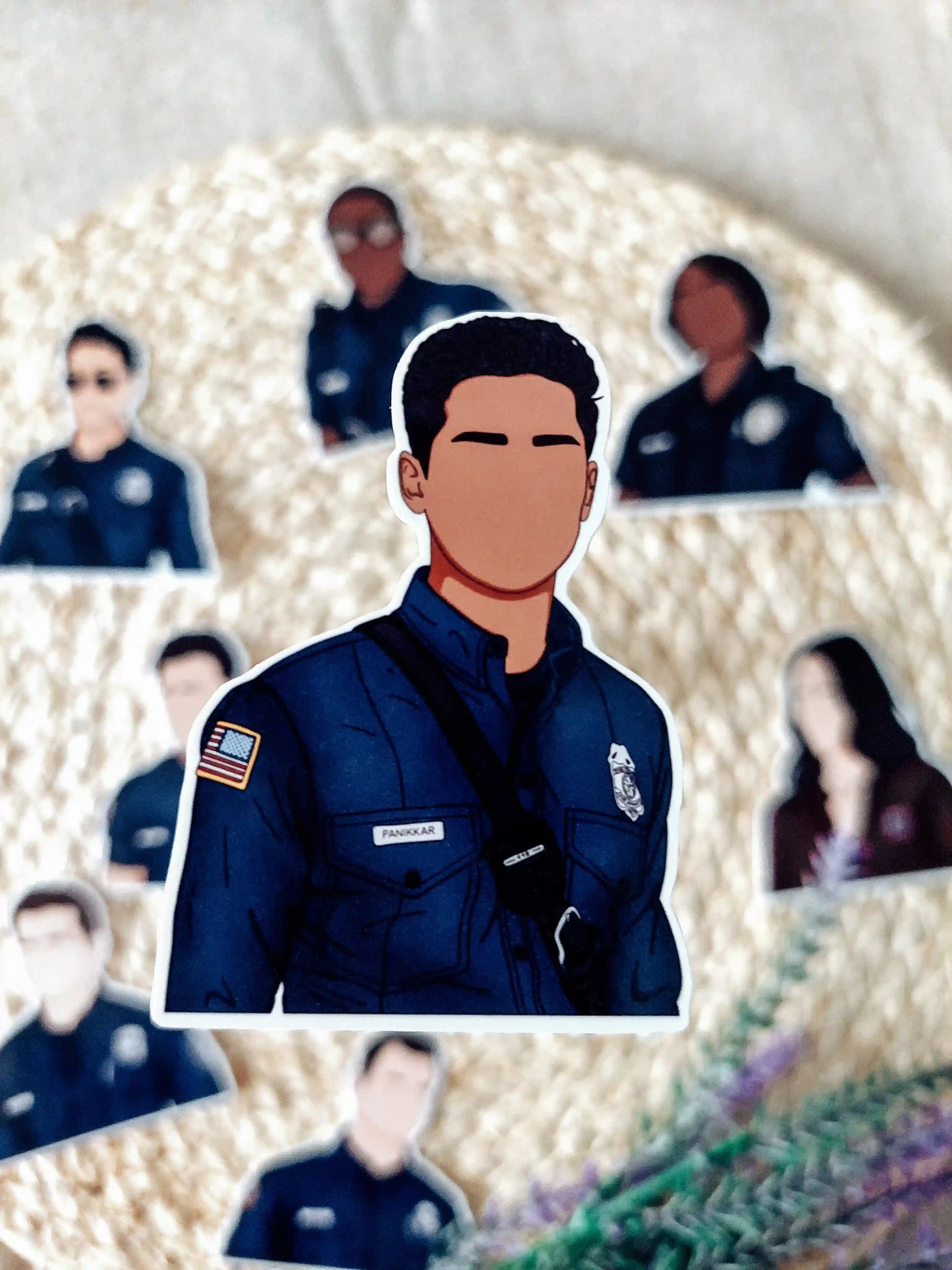 Close up photo of a vinyl sticker inspired by 9-1-1, featuring Ravi Panikkar.