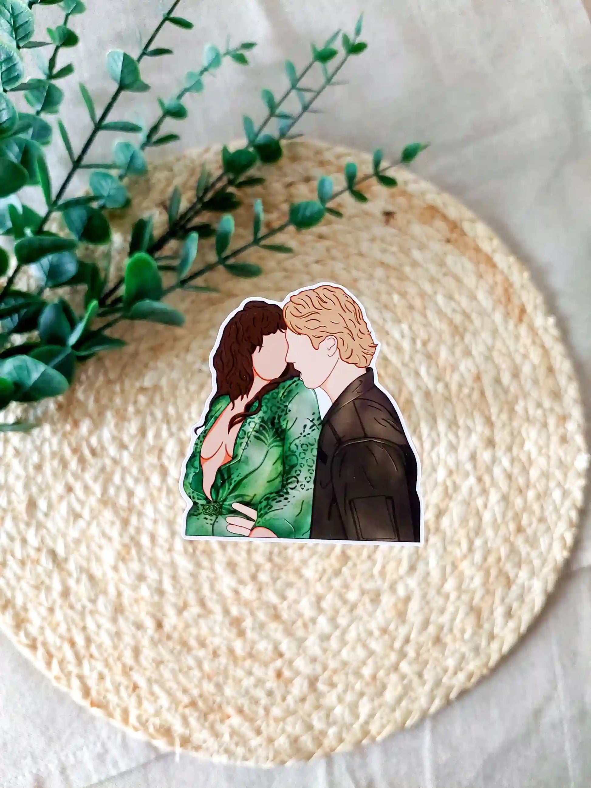 Off Campus inspired sticker photographed on a rattan placemat, featuring an illustration of Allie and Dean dancing.