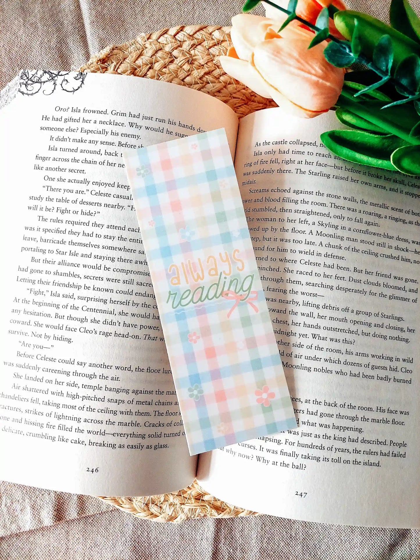 "Always Reading" bookmark placed on an open book, featuring a colourful pastel gingham pattern with small flowers and a bow.