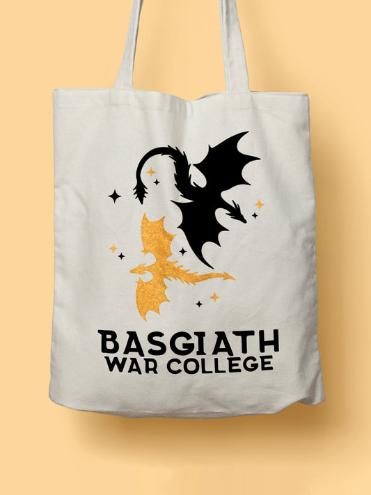 Cotton canvas tote bag featuring a black and a golden dragon illustration with the text “Basgiath War College”, photographed on a yellow background.
