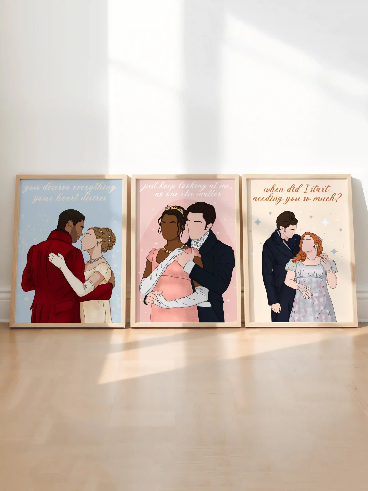 Bundle of three art prints inspired by Bridgerton, featuring illustrations of three couples from the series, displayed side by side in light wooden frames.