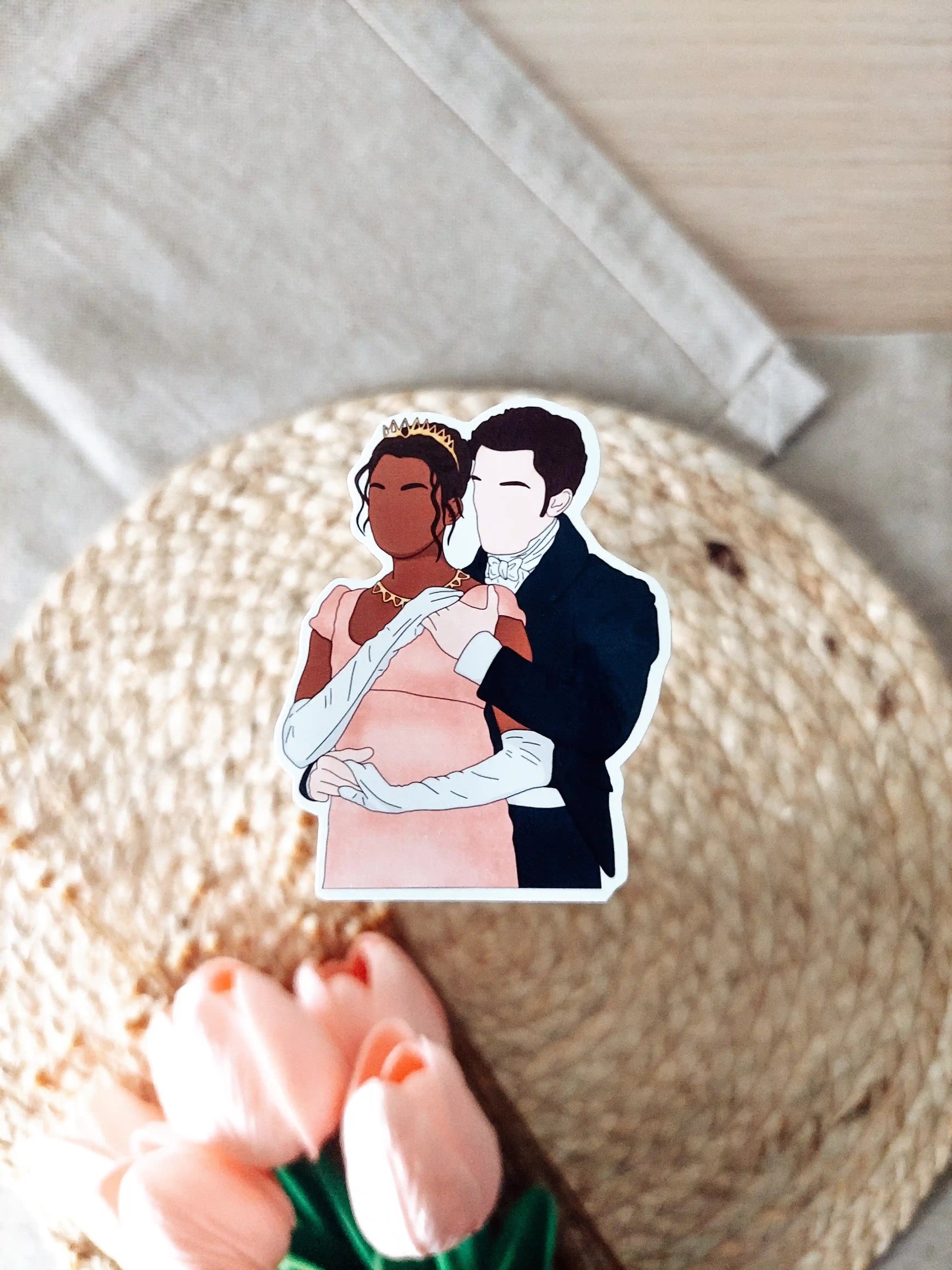 Close up photo of a vinyl sticker inspired by Bridgerton, featuring Kate and Anthony.