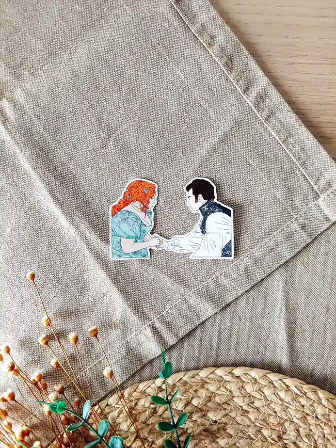 Close up photo of a vinyl sticker inspired by Bridgerton, featuring Penelope and Colin.