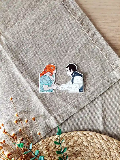 Close up photo of a vinyl sticker inspired by Bridgerton, featuring Penelope and Colin.