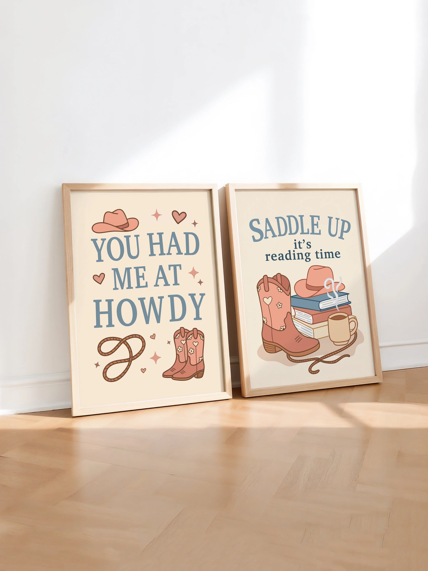 Set of two art prints inspired by cowboy romance books, featuring western-themed illustrations and the text "You Had Me at Howdy" on one and "Saddle Up, it’s reading time" on the other, displayed side by side in frames.