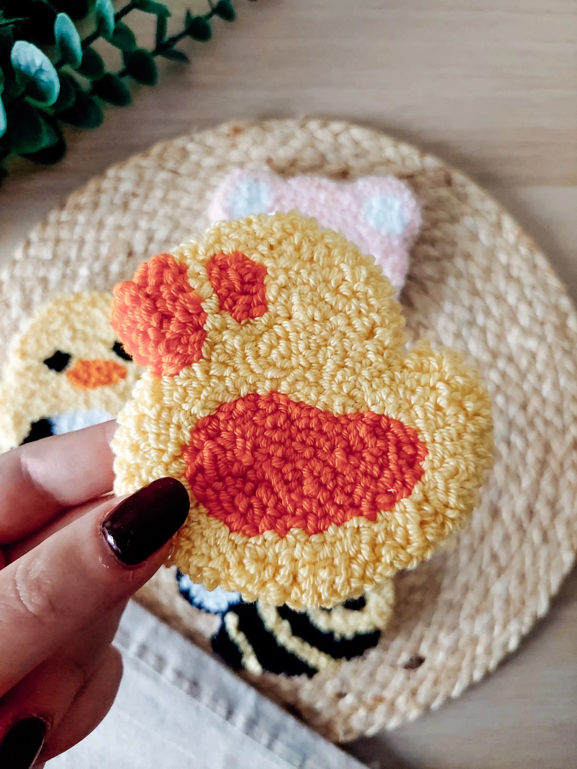 Handmade punch needle coaster, featuring a cute yellow and orange duck.