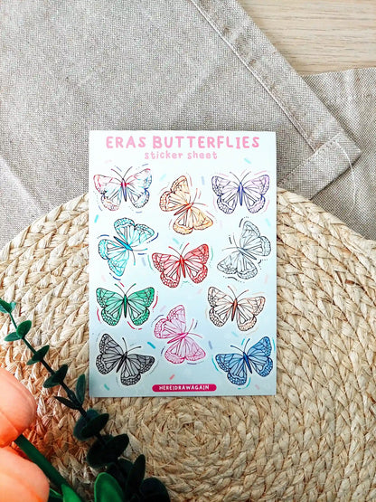 Butterfly sticker sheet featuring colorful butterflies inspired by Taylor Swift eras, photographed on a woven mat.