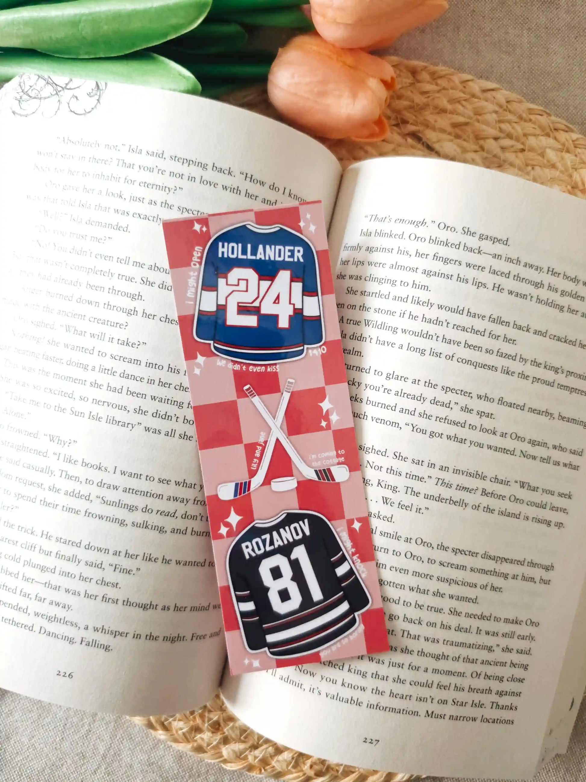 Glossy laminated bookmark featuring Hollander #24 blue jersey and Rozanov #81 black jersey with crossed hockey sticks, a puck and quotes scattered on a red checkered background.