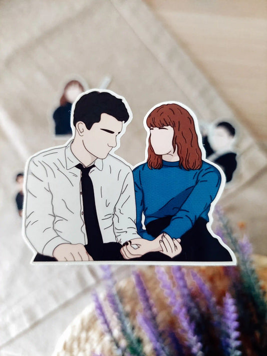 Close up photo of a vinyl sticker inspired by Lockwood & Co, featuring Lucy and Anthony.