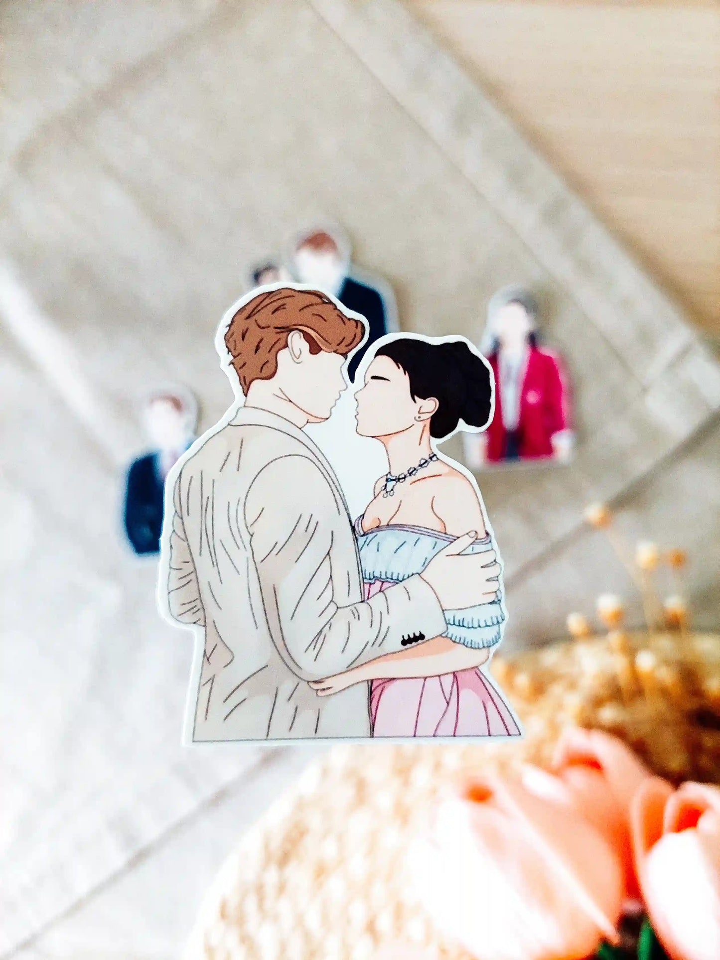 Close up photo of a vinyl sticker inspired by Maxton Hall, featuring Ruby Bell and James Beaufort.