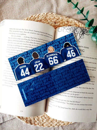 Off Campus inspired bookmark displayed on an open book, featuring illustrations of "Graham 44", "Logan 22", "Di Laurentis 66" and "Tucker 46" from behind in their jerseys on the front, and a blue Off Campus text pattern on the back.