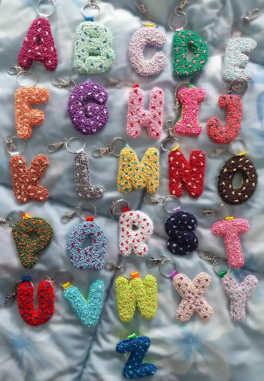 Colorful alphabet keychains on a textured surface