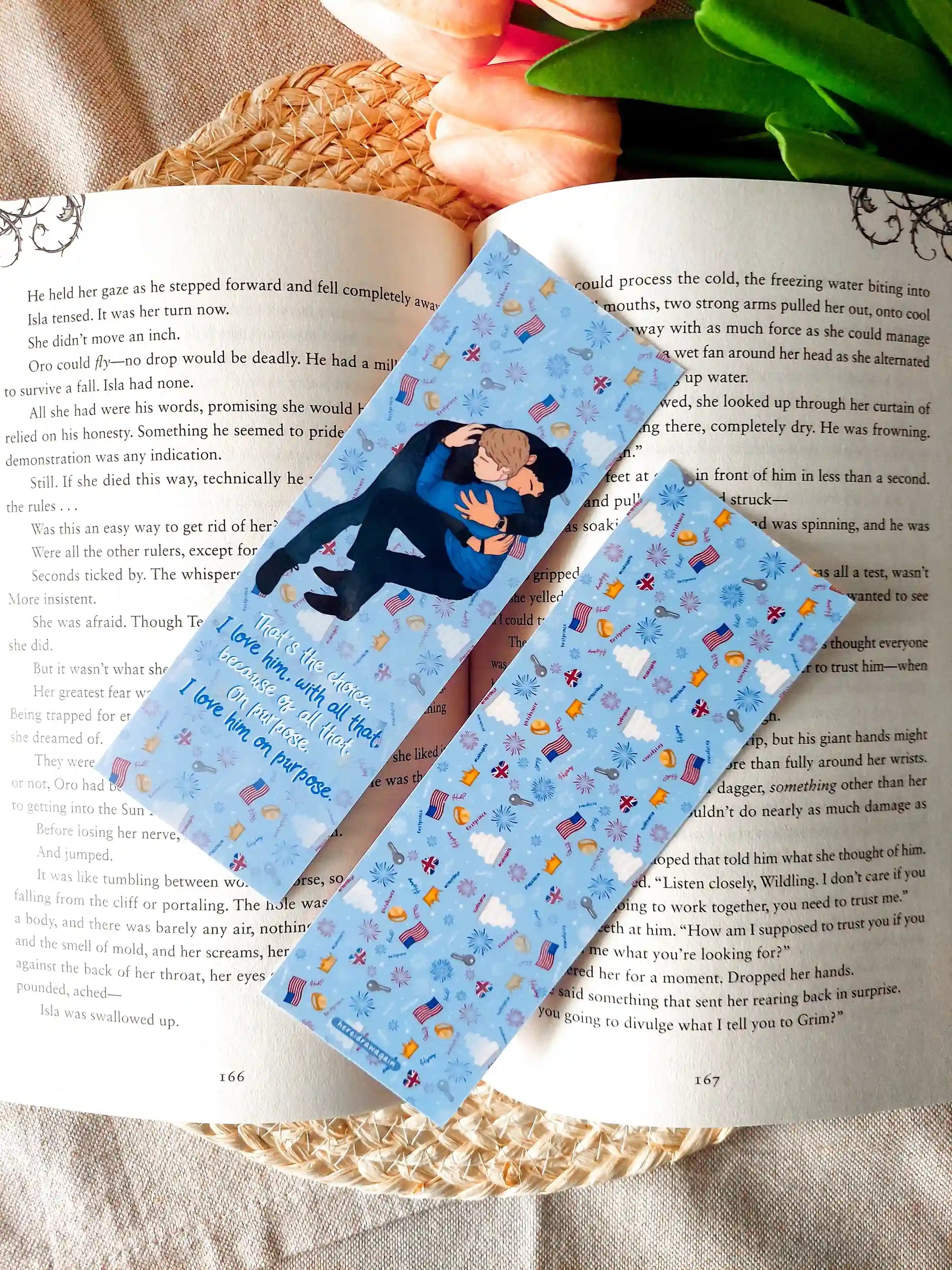 Two-sided Red, White & Royal Blue bookmark showing the front and back: the front features an illustration of Henry and Alex and quote from the book, while the back has a blue patterned design, resting on an open book.