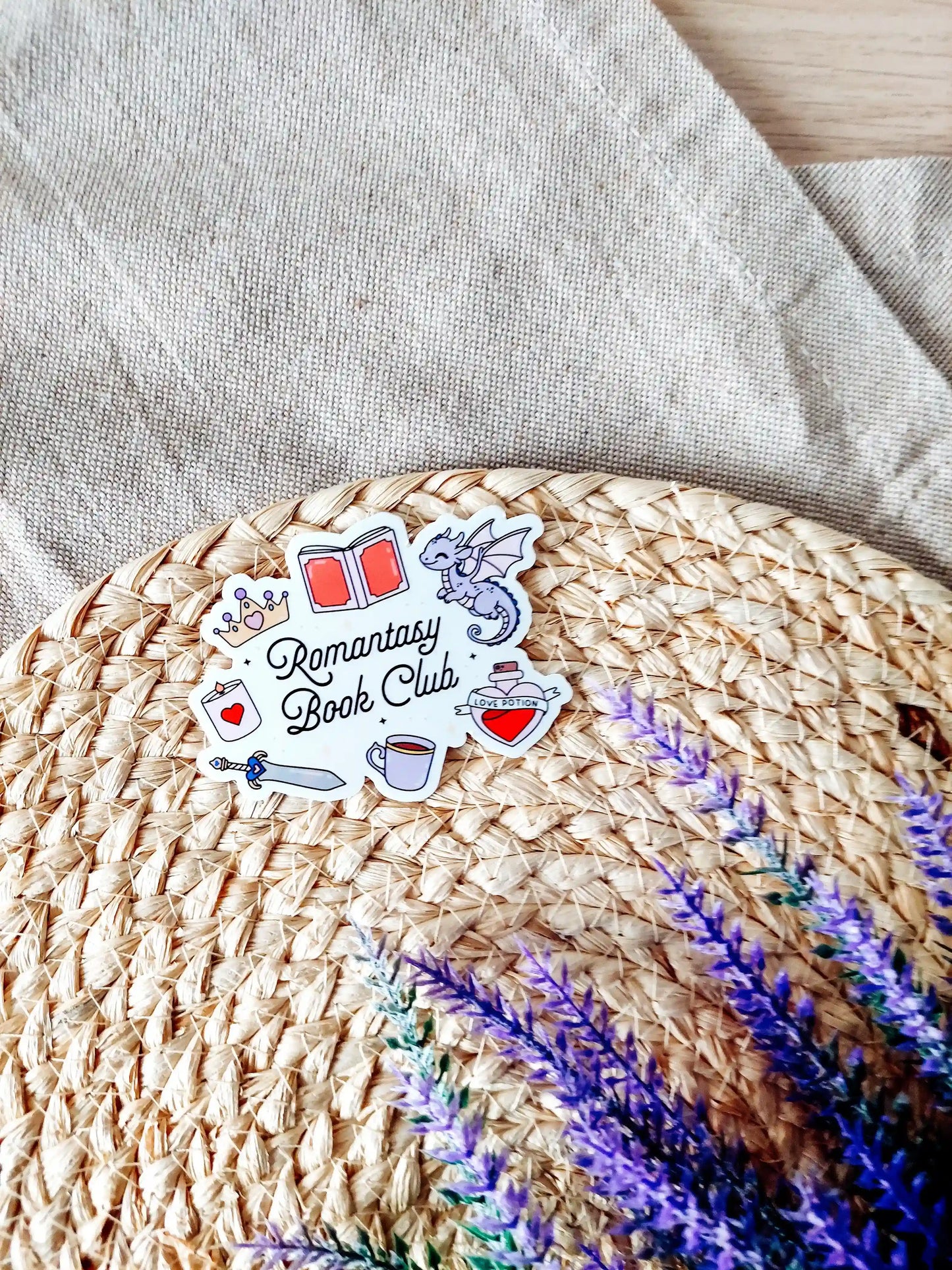 Vinyl sticker with the text "Romantasy Book Club" surrounded by fantasy-themed illustrations including a dragon, crown, sword. 