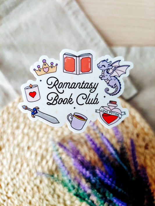 Vinyl sticker with the text "Romantasy Book Club" surrounded by fantasy-themed illustrations including a dragon, crown, sword. 