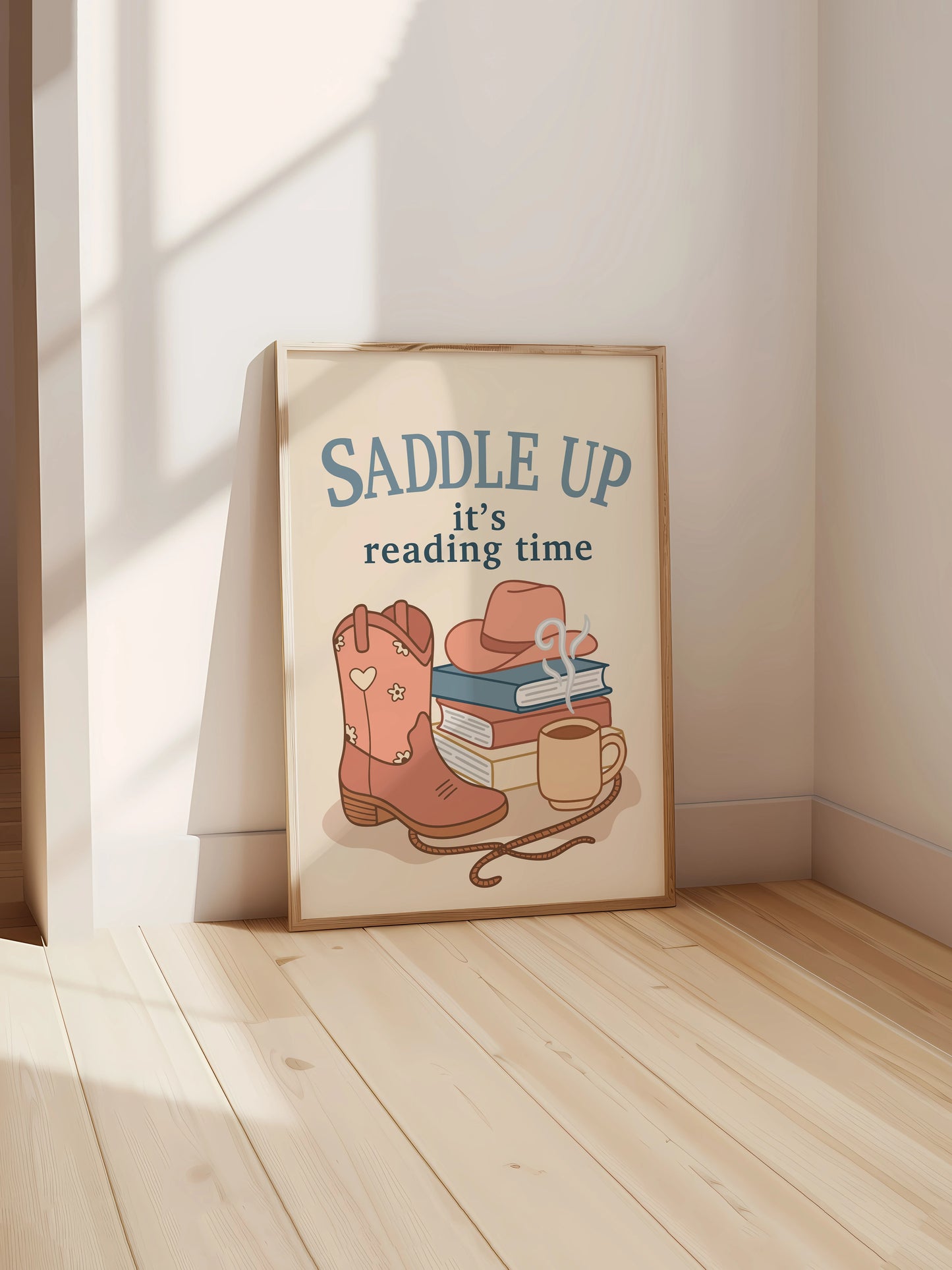Art print inspired by cowboy romance books featuring the phrase "Saddle Up, it’s reading time" with illustrated boots, books, a hat and a mug, displayed in a frame.