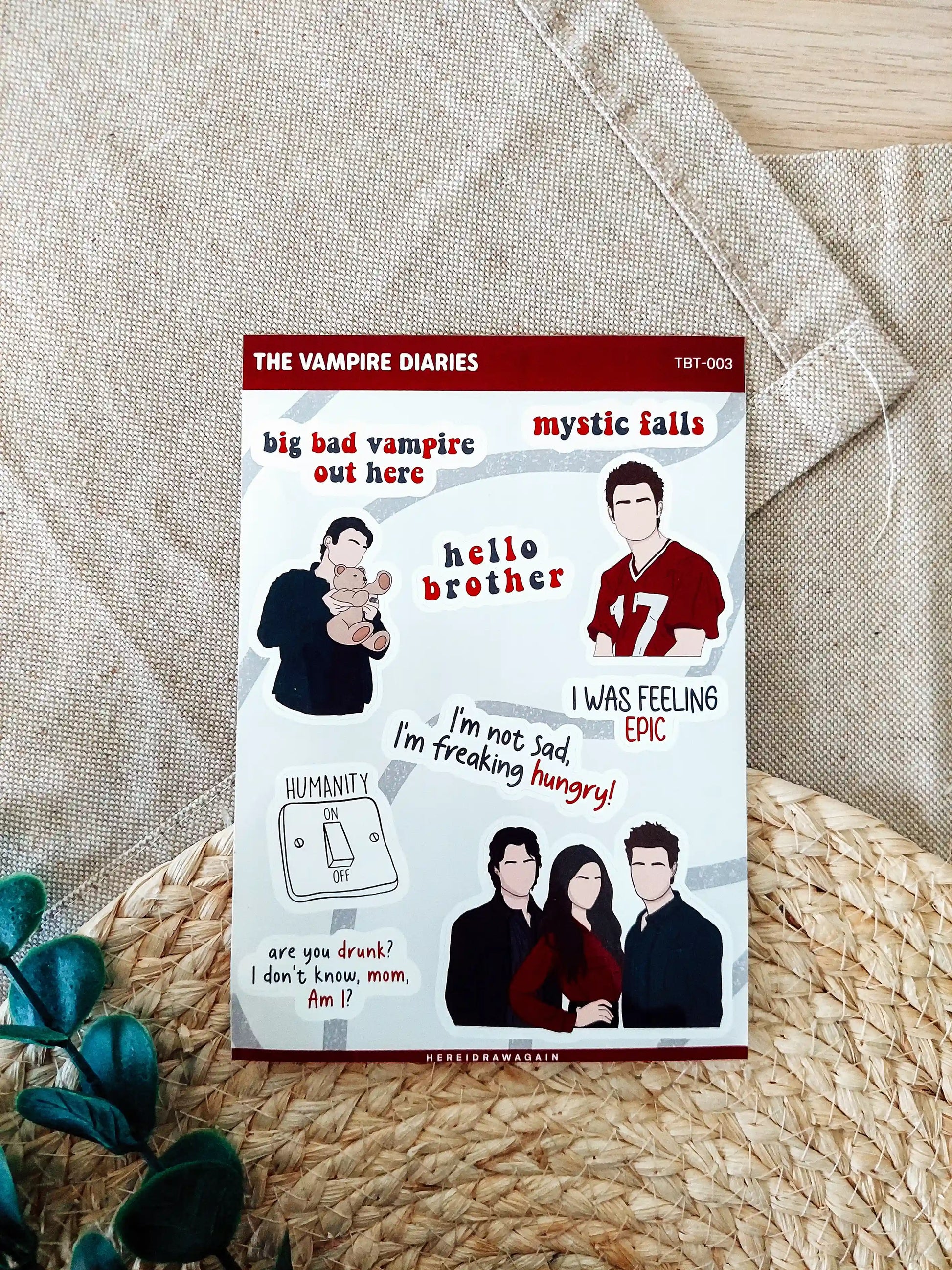 The Vampire Diaries themed sticker sheet featuring iconic symbols, quotes and details from the show, photographed on a woven mat.