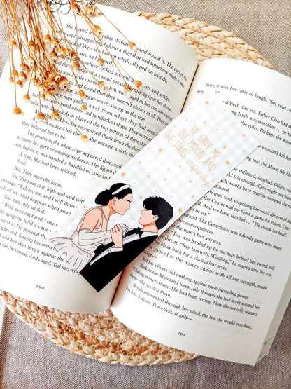 Bookmark inspired by The Summer I Turned Pretty, featuring Belly and Conrad with the quote "He gave me the moon and the stars, infinity." on a gold gingham background with little gold stars, resting on an open book.