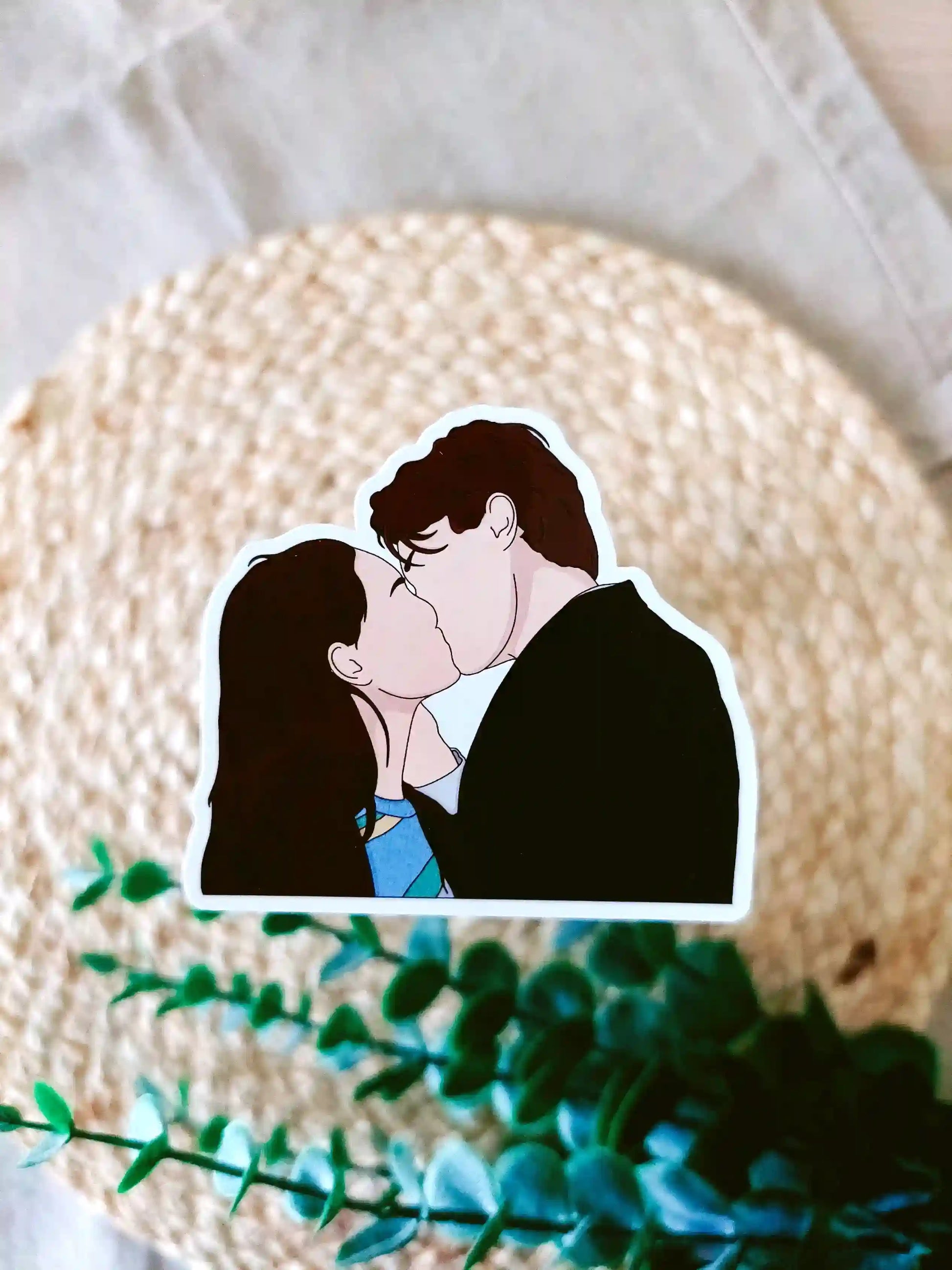 Close up photo of a vinyl sticker inspired by The Summer I Turned Pretty, featuring Belly and Conrad kissing.
